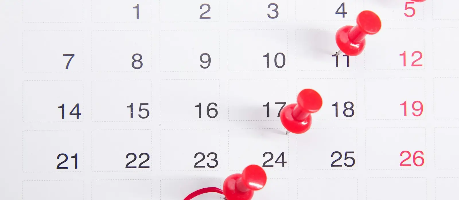 A calendar with red pins and the 30th circled